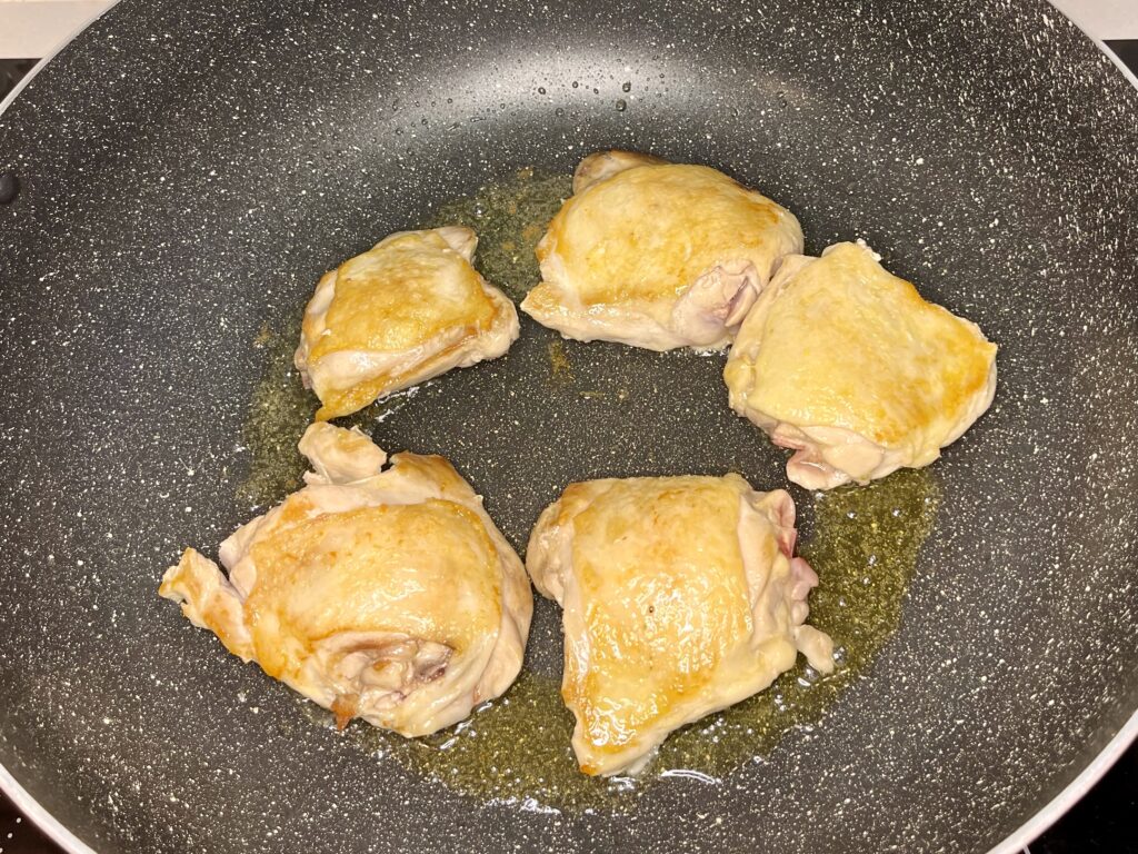 chicken browning in a pan