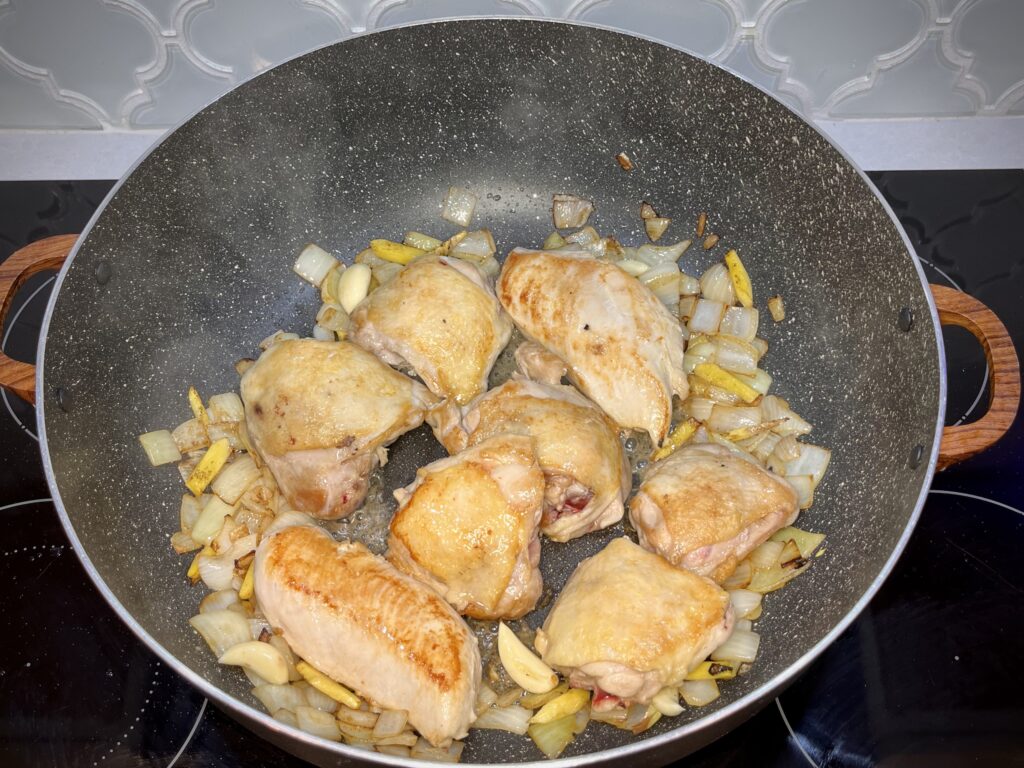 chicken, onion, garlic, and ginger in a pan