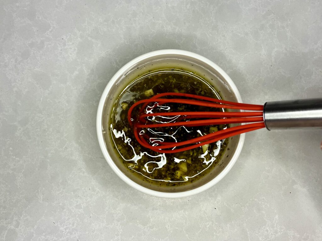 ingredients for salad dressing being whisked