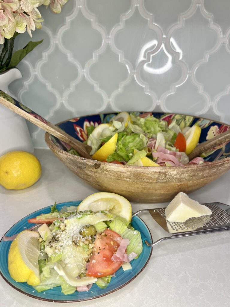 Assembled Spanish salad on a plate with freshly grated cheese