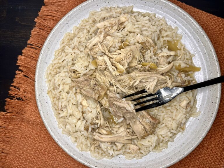 Cooked chicken adobo on a plate with rice