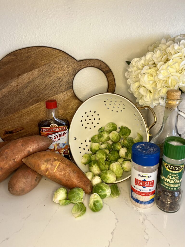 sweet potatoes, brussel sprouts, maple syrup, pepper, slat and olive oil on the counter