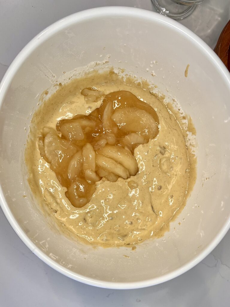 Canned apple pie filling added to mixture in bowl
