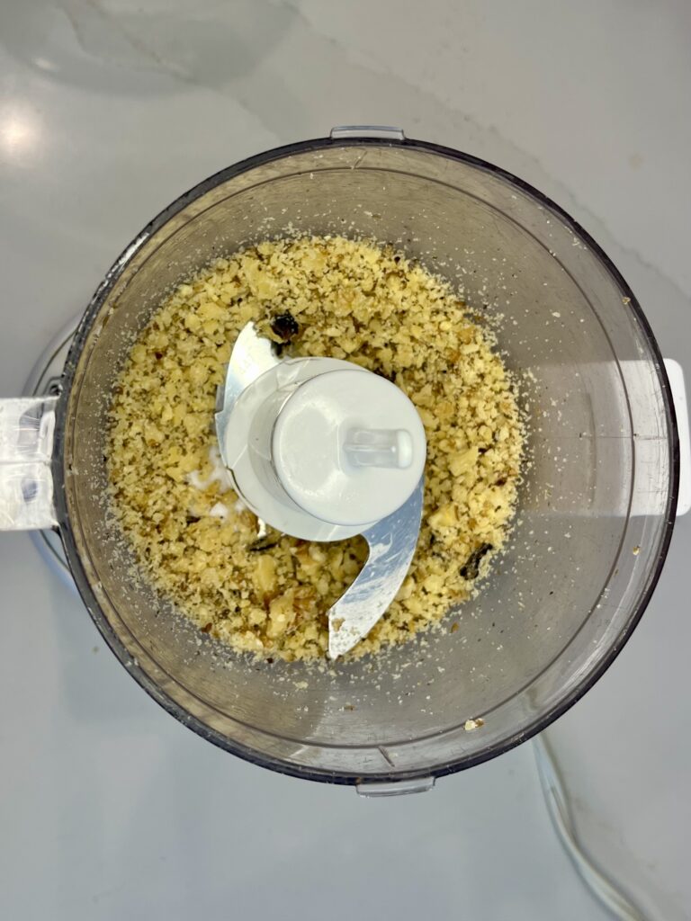 Finely ground walnuts in food processor.