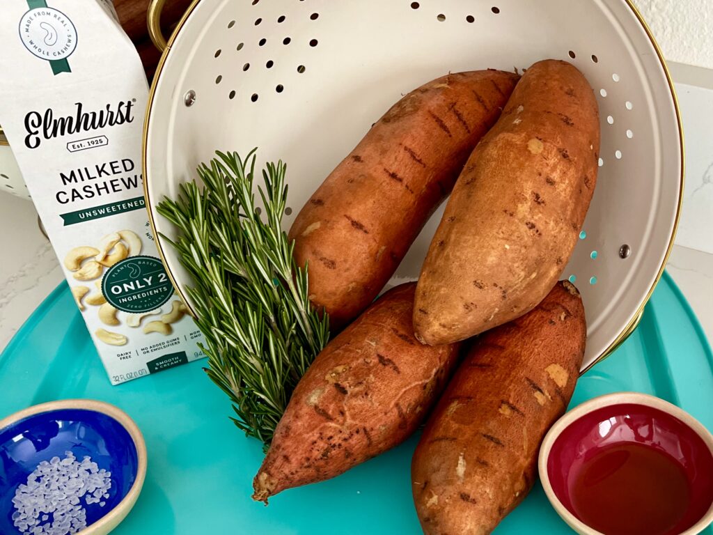 4 Sweet potatoes, salt, olive oil, rosemary, and cashew milk on a baking sheet 