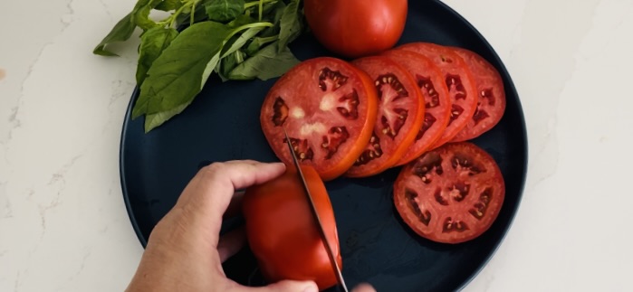 slicing tomatoes on a plate
