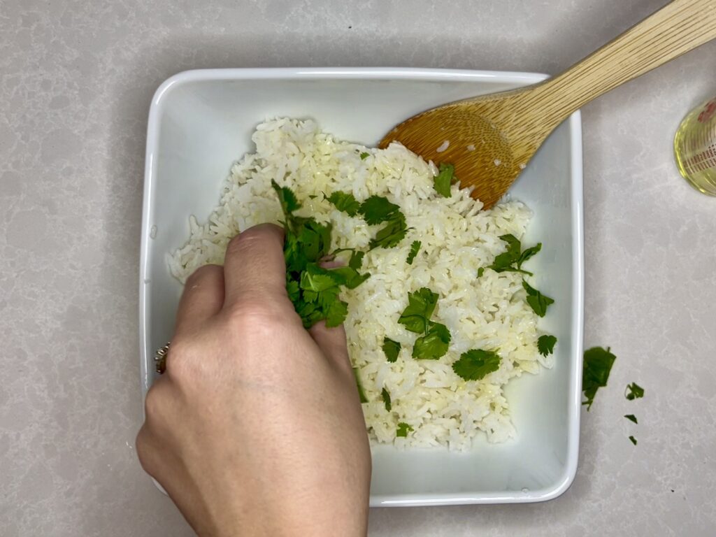 chopped cilantro being added to bowl