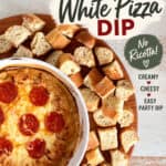 Hot White Pizza Dip in a white dish surrounded by chunks of bread