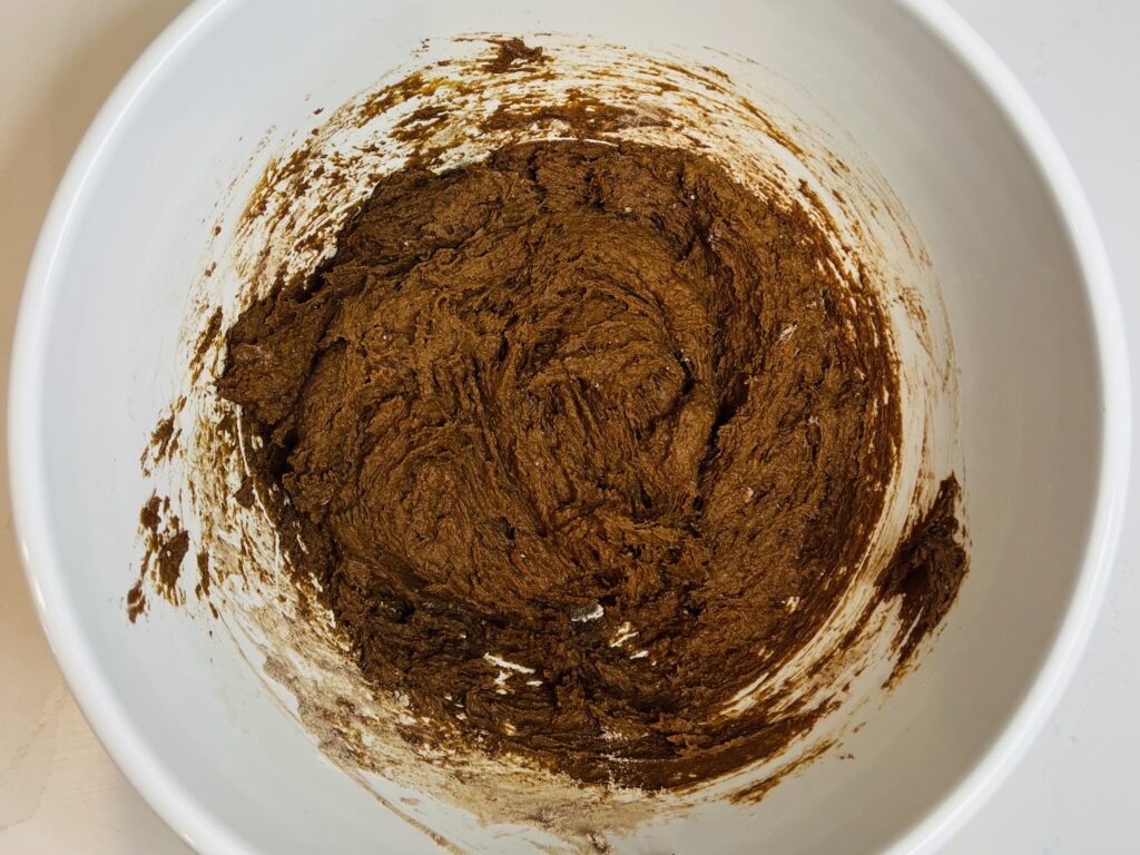 Cake batter and pumpkin puree mixed together in a large mixing bowl