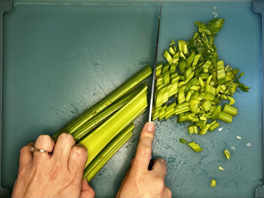 celery being sliced with a knife