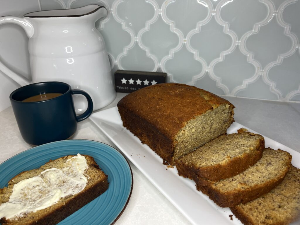 sliced banana bread with butter and coffee