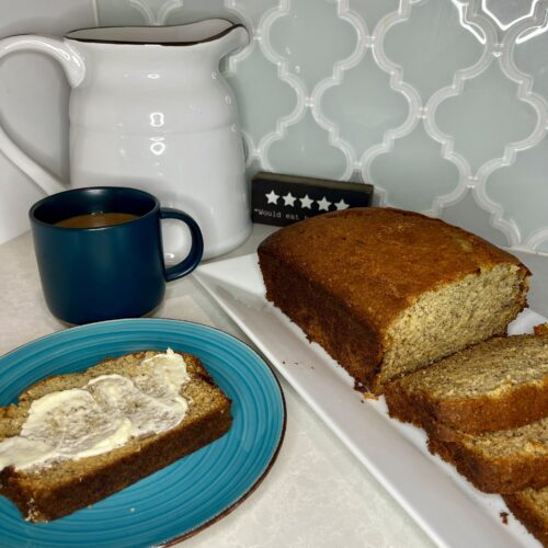 sliced banana bread with butter and a cup of coffee