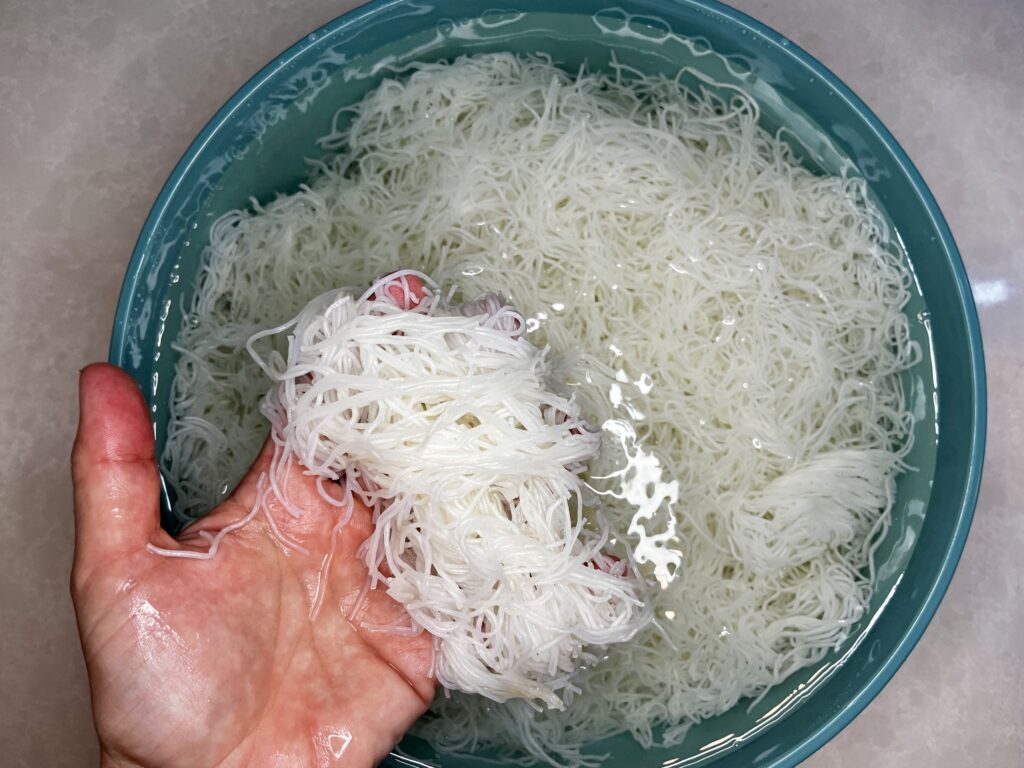 tender rice stick noodles in a bowl of water