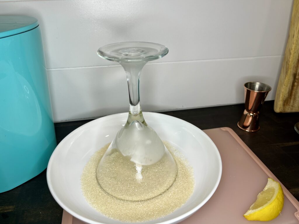 a martini glass being dipped into sugar