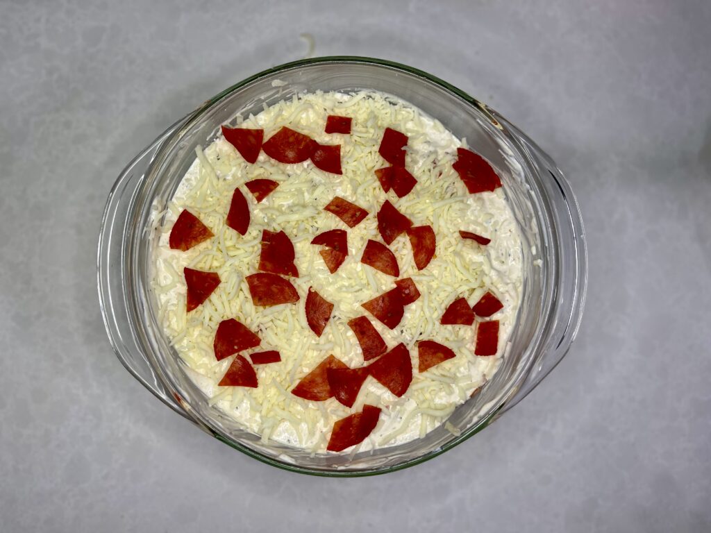 White pizza dip in a casserole dish waiting to be baked