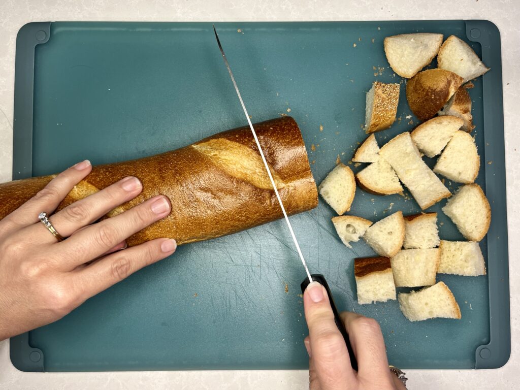 loaf of French bread being cut up