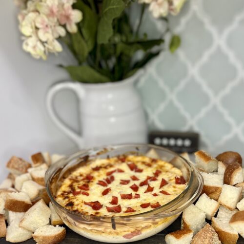 cooked pizza dip in a bowl with cut up bread