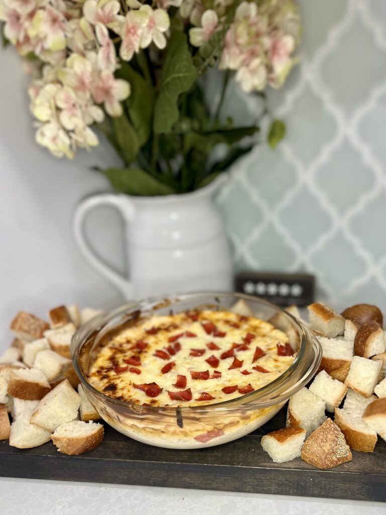 cooked pizza dip in a bowl with cut up bread