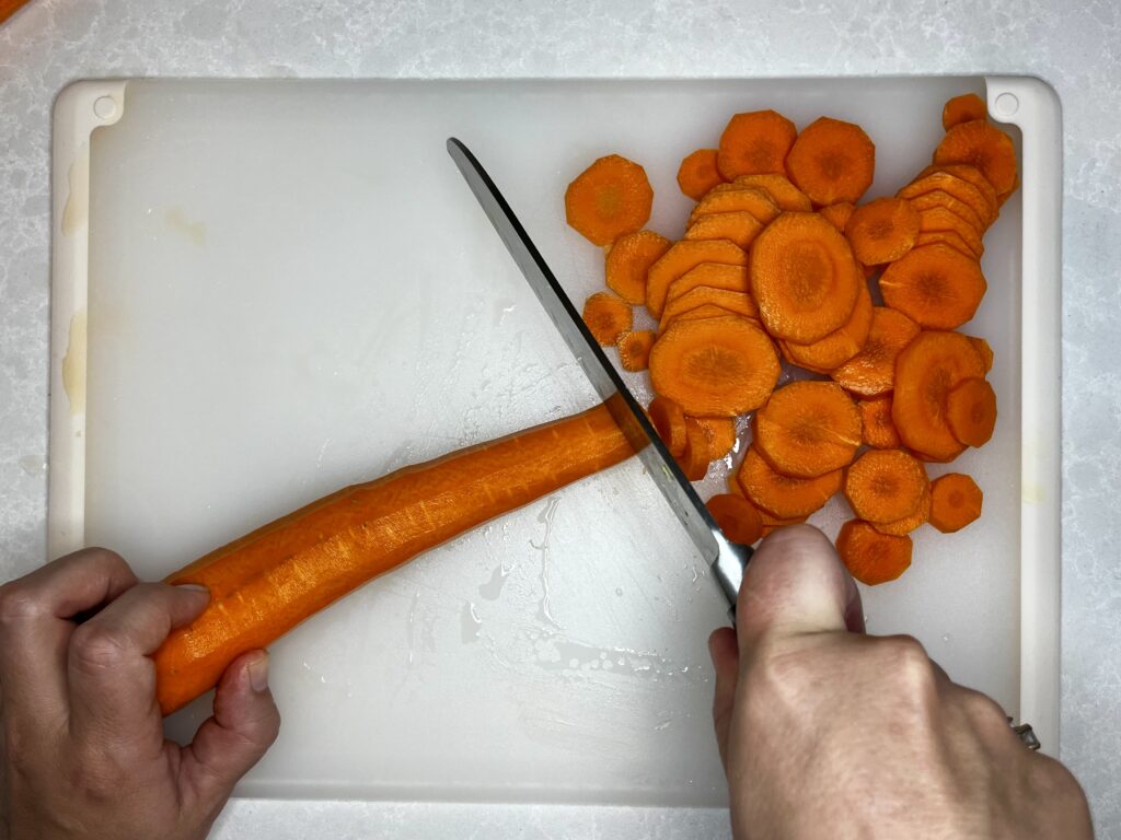 peeled carrots being sliced 