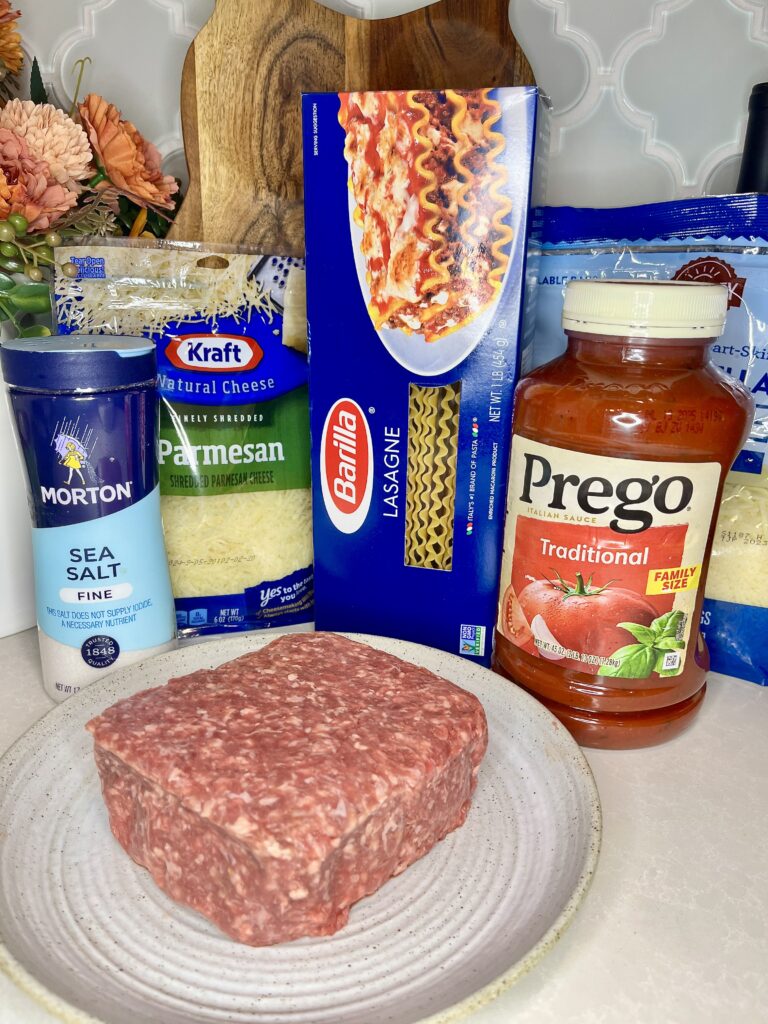 Ingredients for lasagna - ground beef, noodles, sauce, cheese, salt