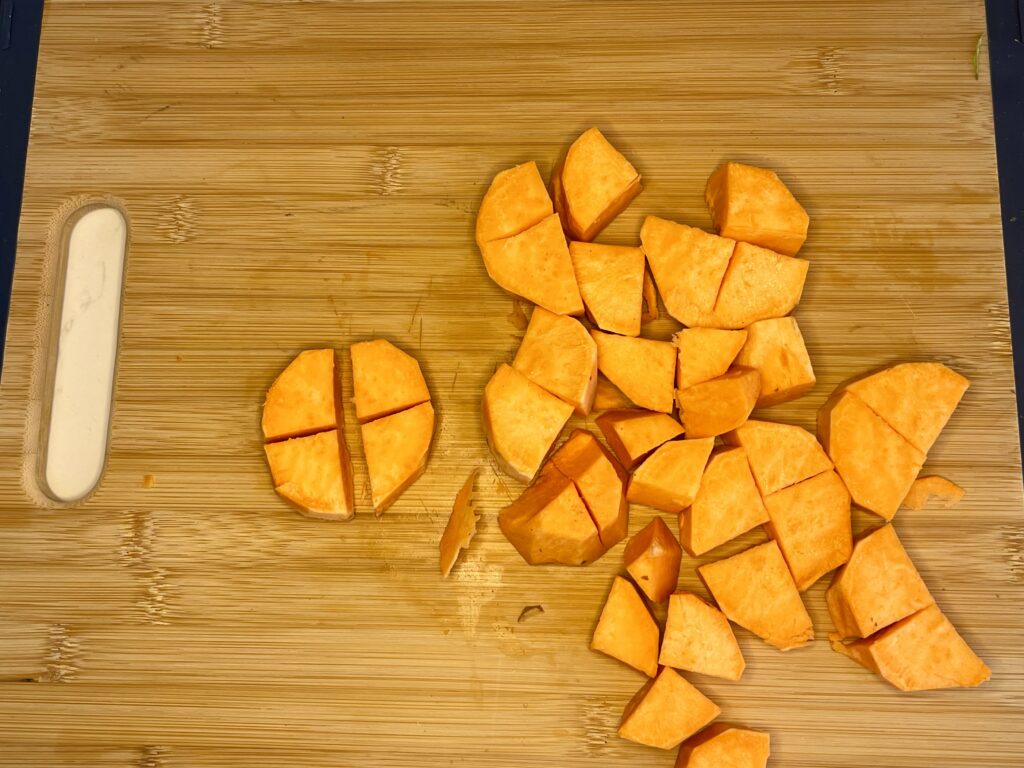 sweet potatoes cut on a cutting board.
