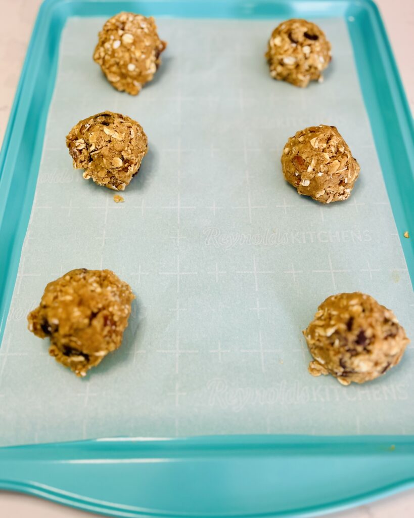 Scooped cookie dough onto parchment paper lined baking sheets, spacing 3 inches apart.
