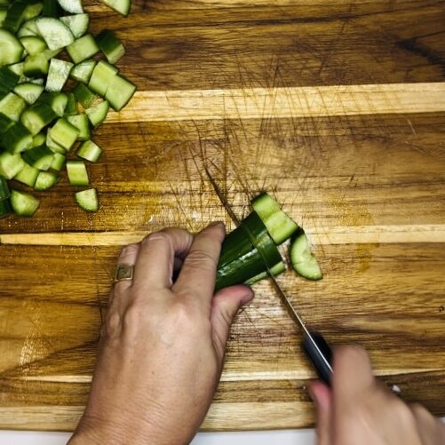 Finely diced cucumbers on a cutting board
