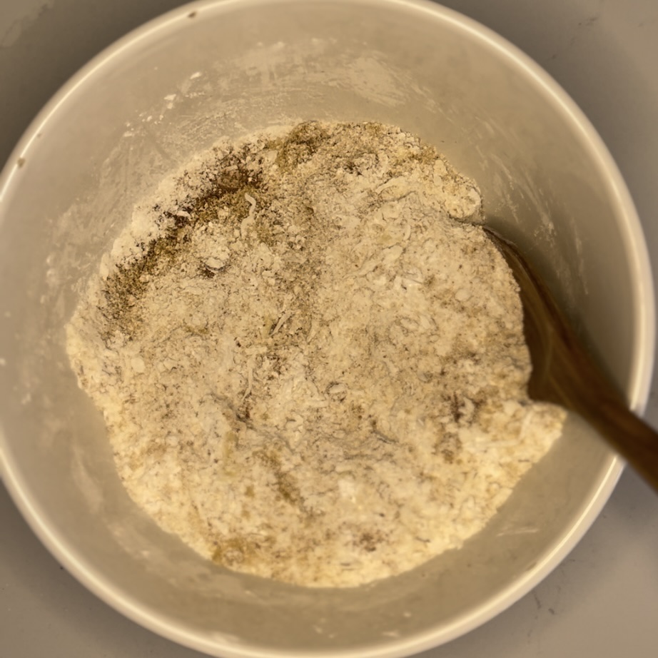 coconut flour, arrowroot flour, sugar, cinnamon, salt, almonds, shredded coconut in a bowl.
