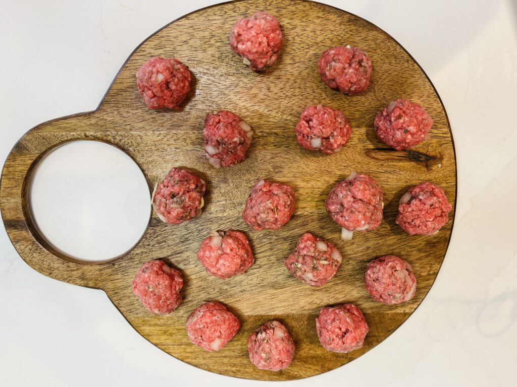 17 meatballs on a cutting board