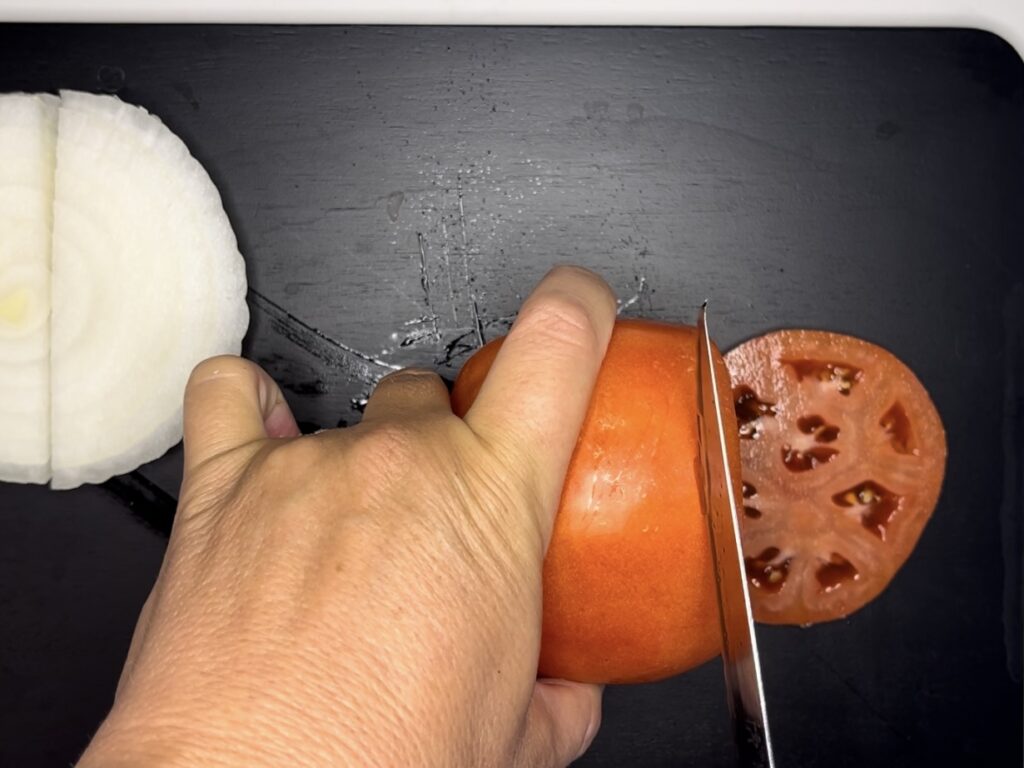 Thinly sliced tomato on a plate
