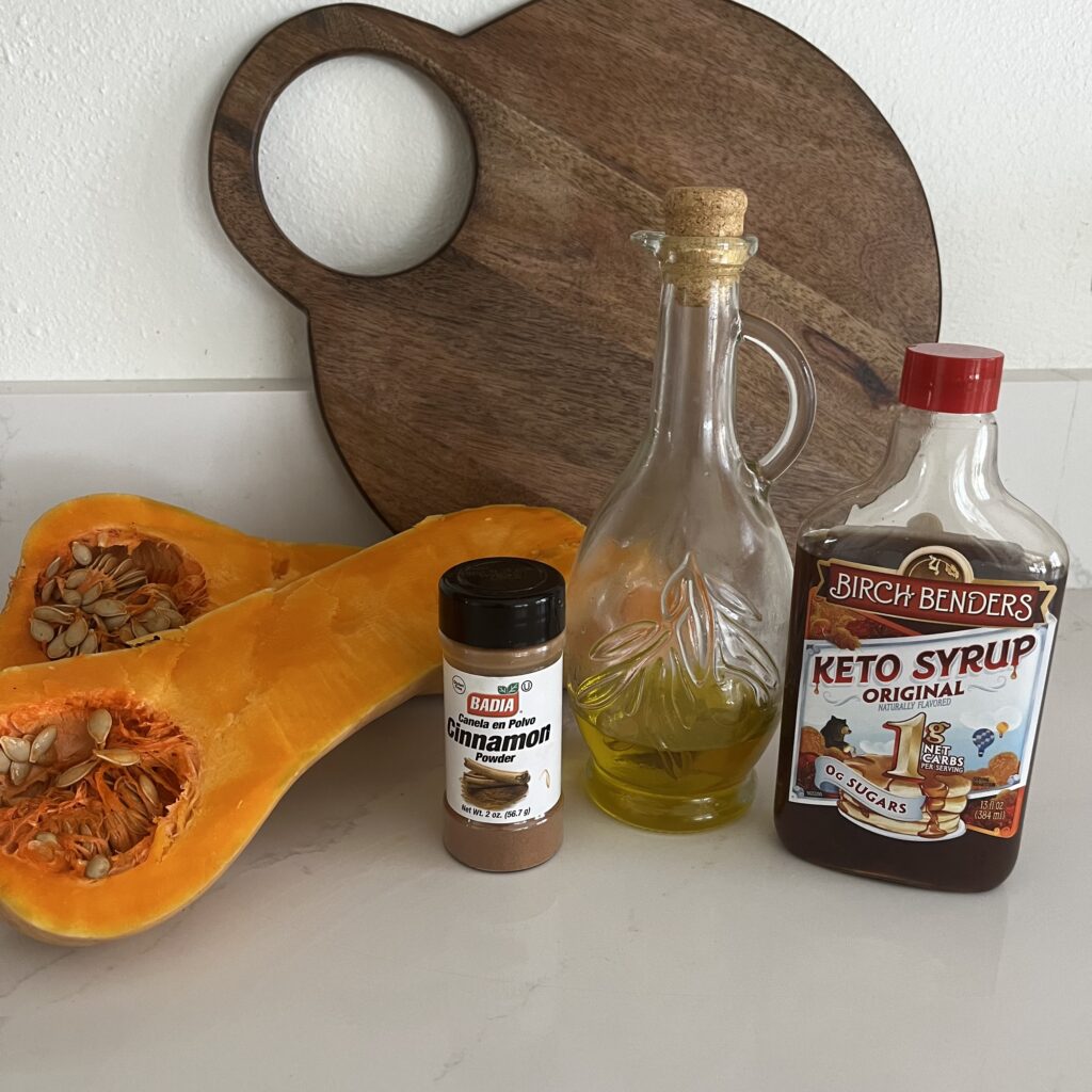 Olive oil, maple syrup, cinnamon, butternut squash on the counter