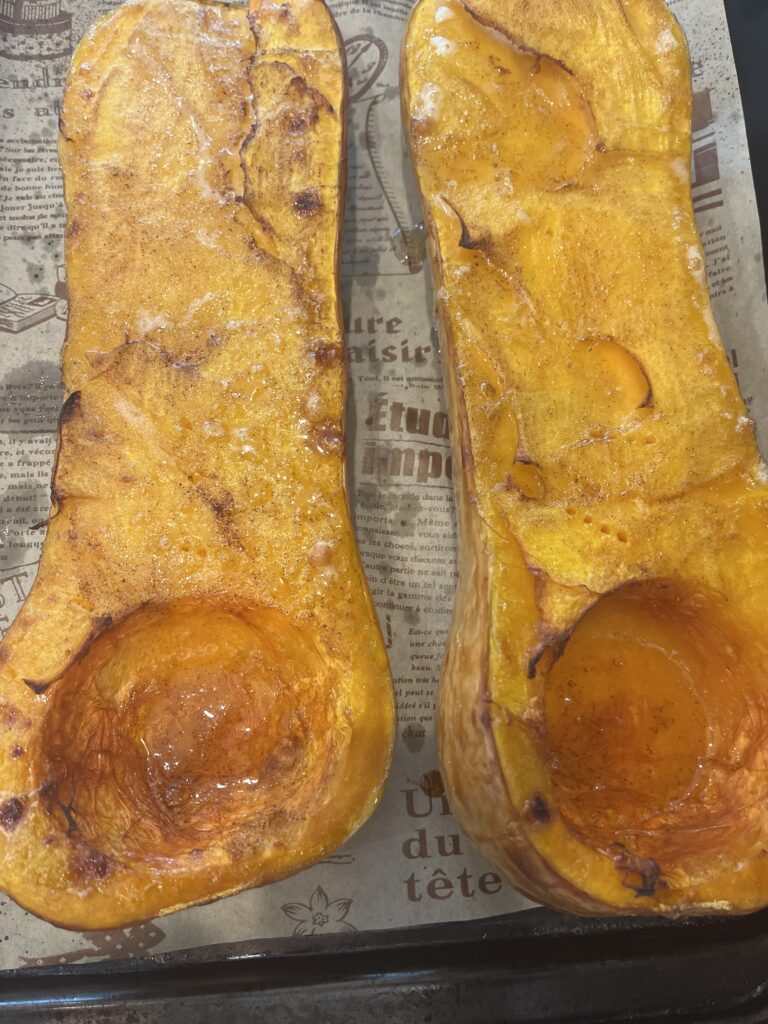 Finished roasted butternut squash on a lined baking sheet
