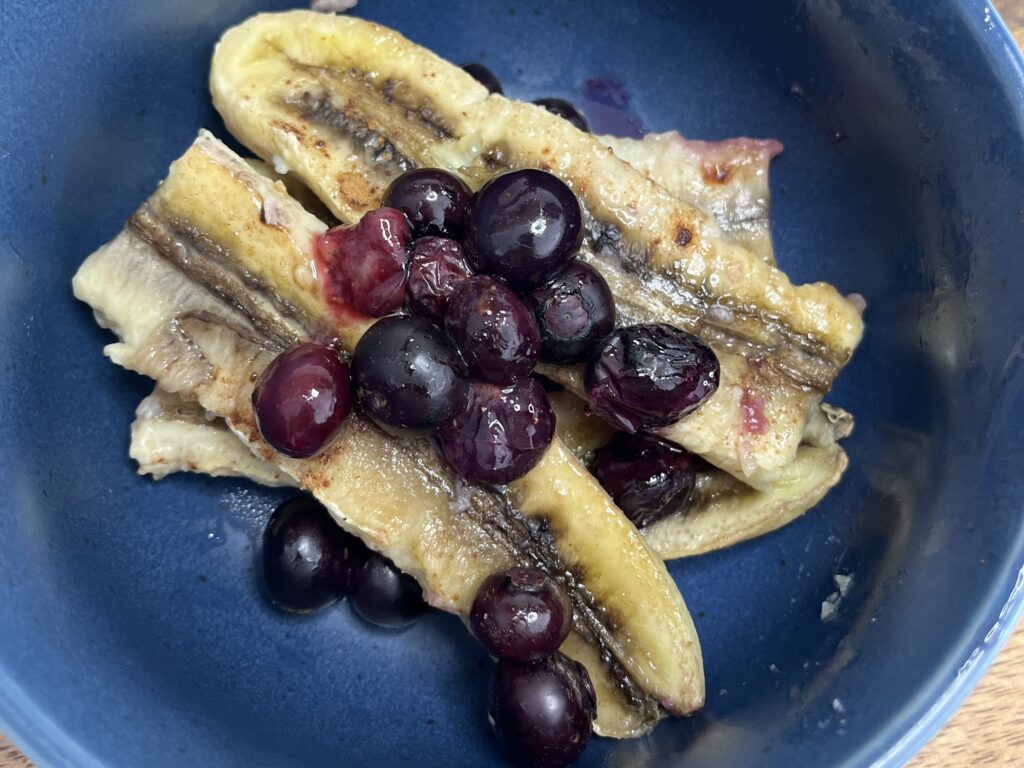 Baked banana and blueberries in a bowl
