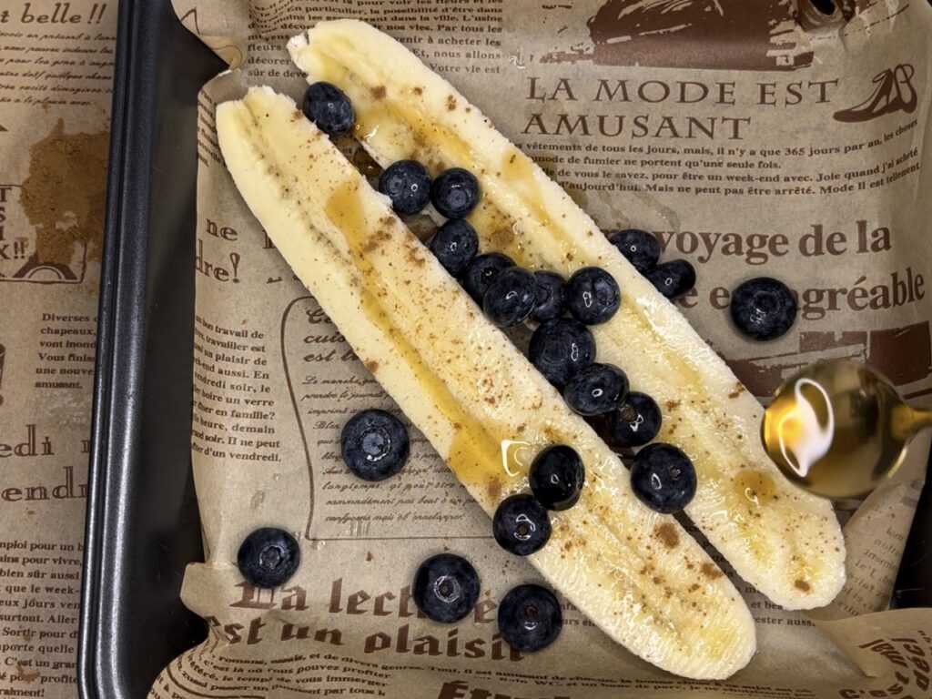 Raw banana with blueberries and maple syrup in a 9x9 baking pan