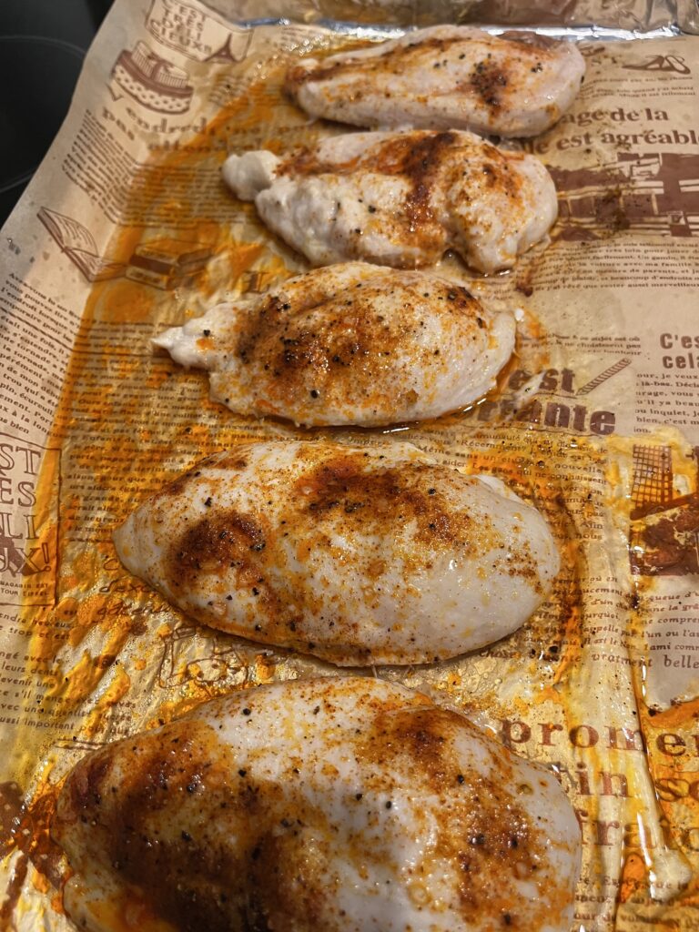 Cooked chicken breasts on baking sheet