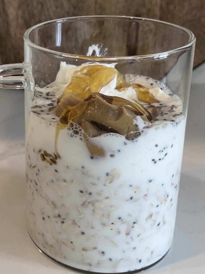 Honey and vanilla extract added to glass jar on the counter