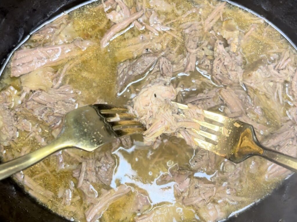 With the forks pulling apart the shredded beef slow cooker