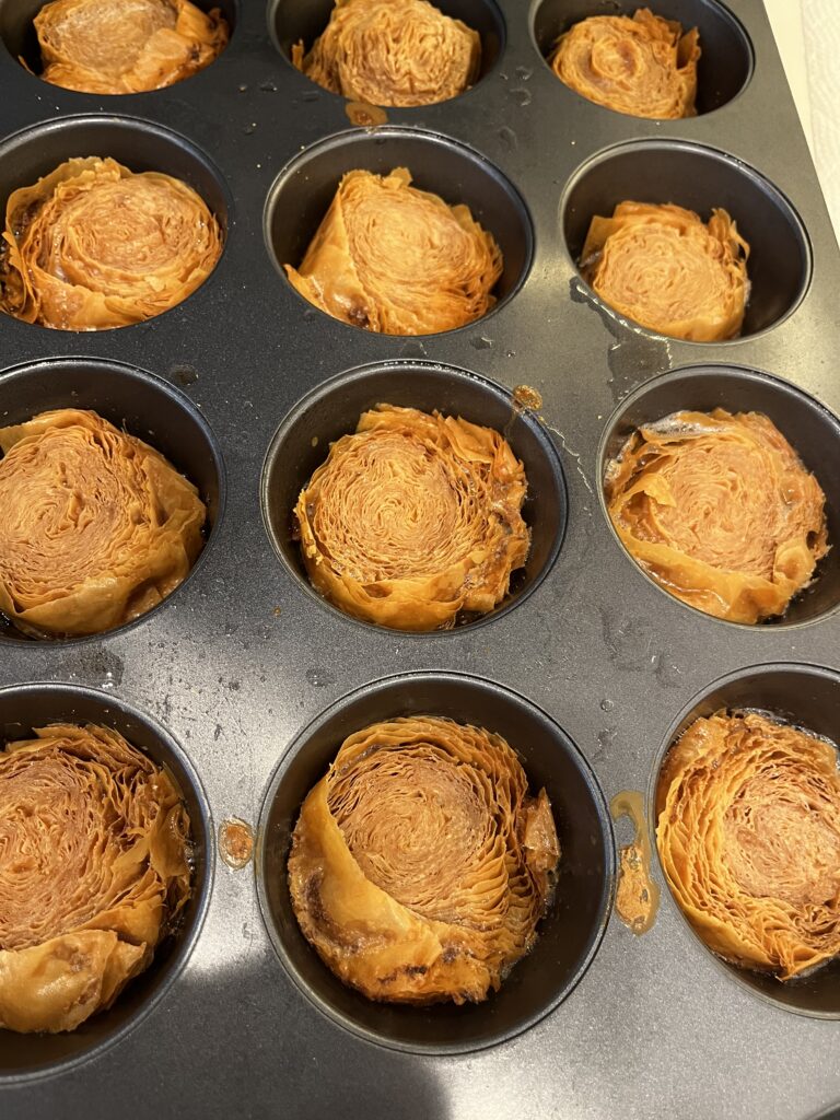 Cooled phyllo pieces in a muffin tin