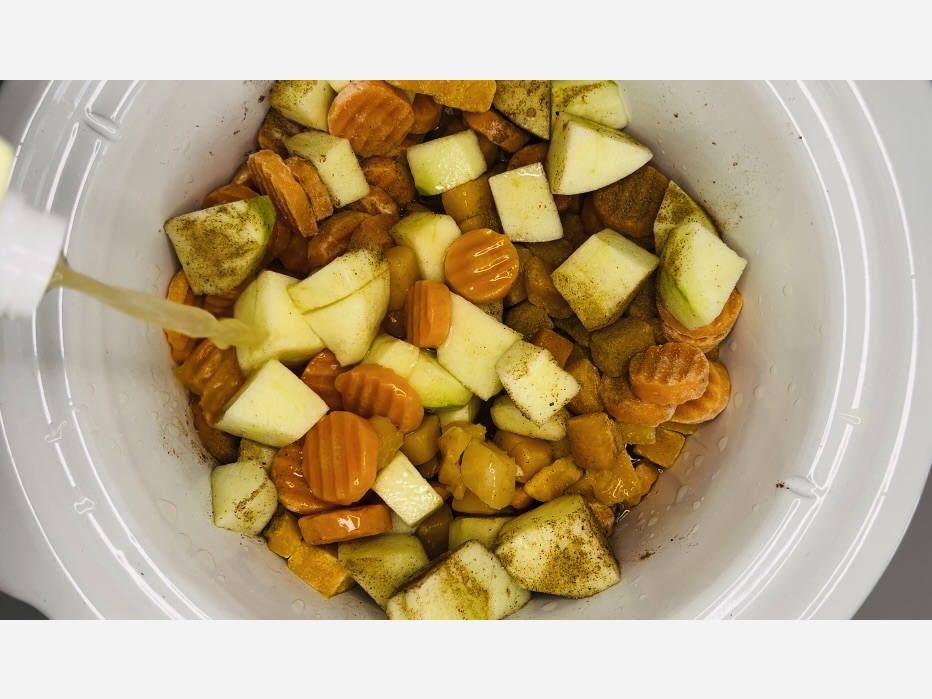 Adding chicken broth to the ingredients.