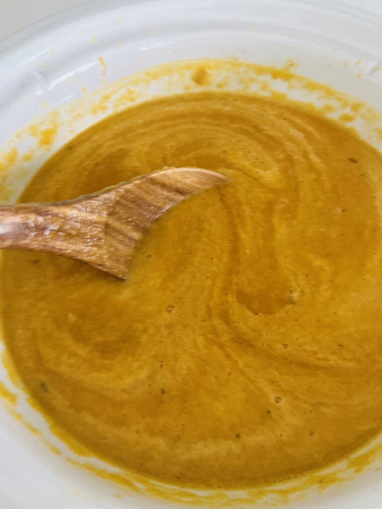 Stirring the coconut milk into the soup in slow cooker