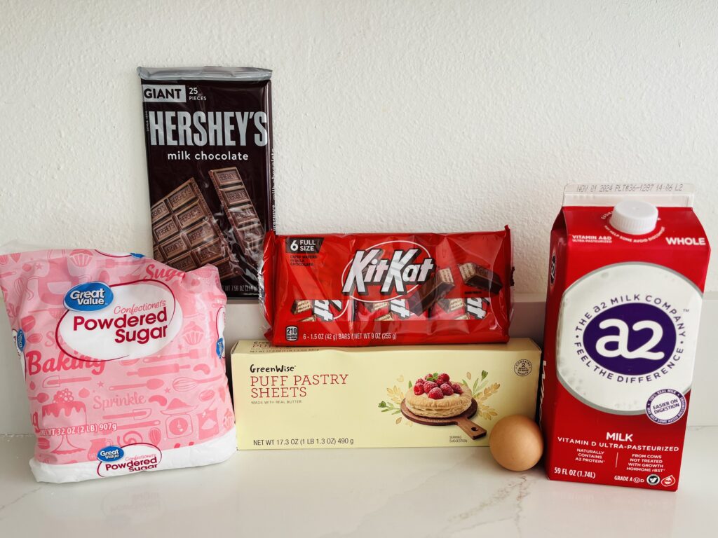 package of puff pastry
KitKat, Hershey's chocolate bars
1 egg, milk and powdered sugar on the counter