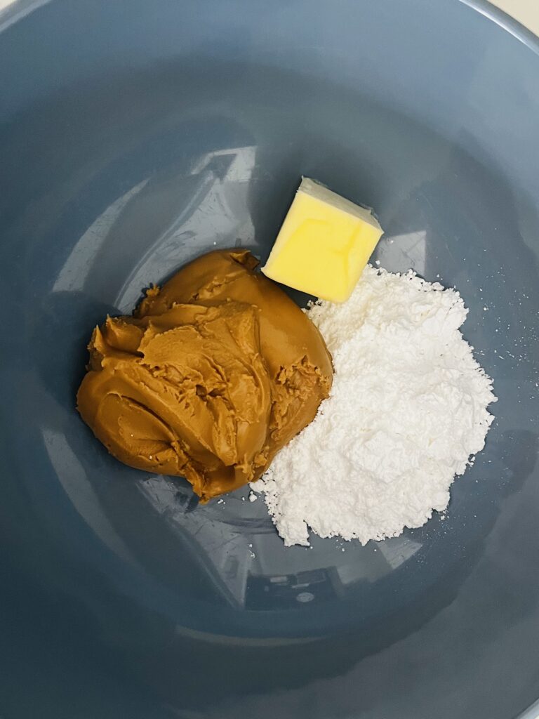 Room temperature butter, peanut butter and powdered sugar in a large mixing bowl