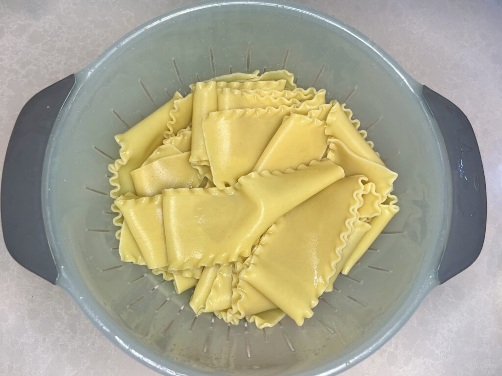 cooked lasagna noodles in a colander