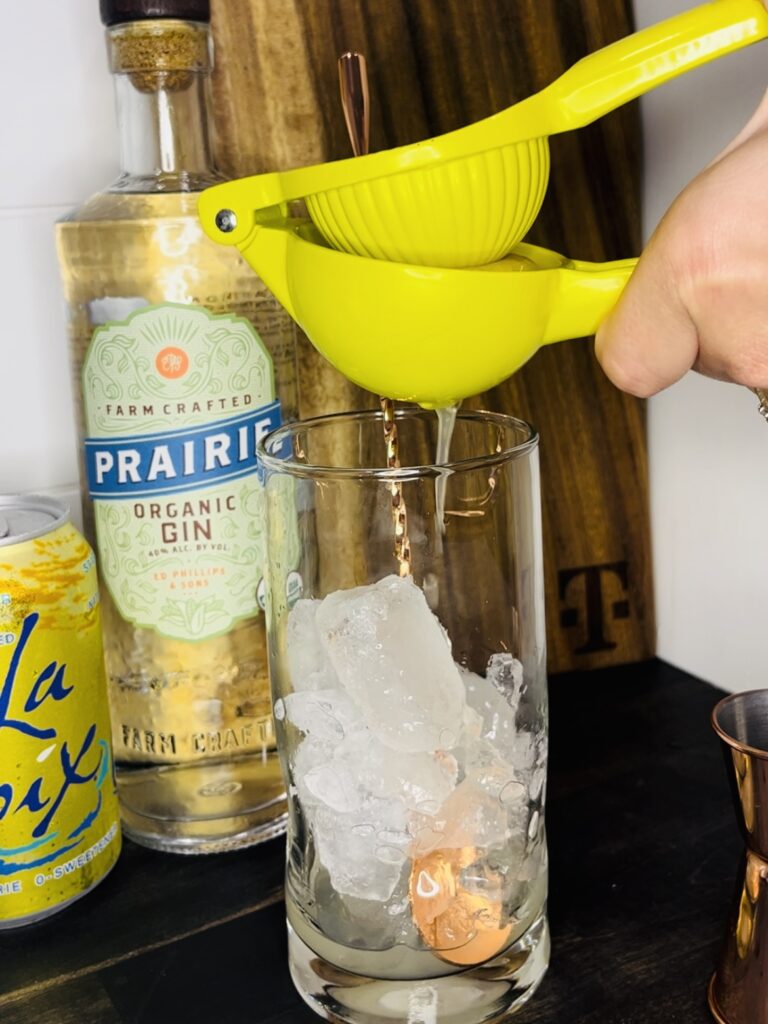 a lemon being juiced into a glass
