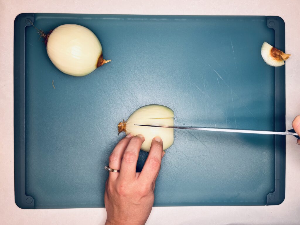 a knife making more slices in an onion