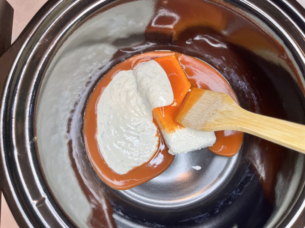 cream cheese, ranch dressing, and buffalo sauce in a slow cooker