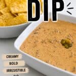 Creamy, bold, and irresistible game day dip served in a white bowl with tortilla chips in the background.