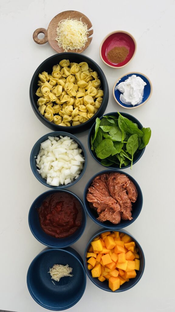 mild/spicy Italian ground turkey sausage, olive oil, onion, garlic cloves, fire roasted tomatoes, parmesan, chicken broth, coconut milk ,spinach-frozen or fresh, cheese tortellini, pumpkin spice, and butternut squash on the counter