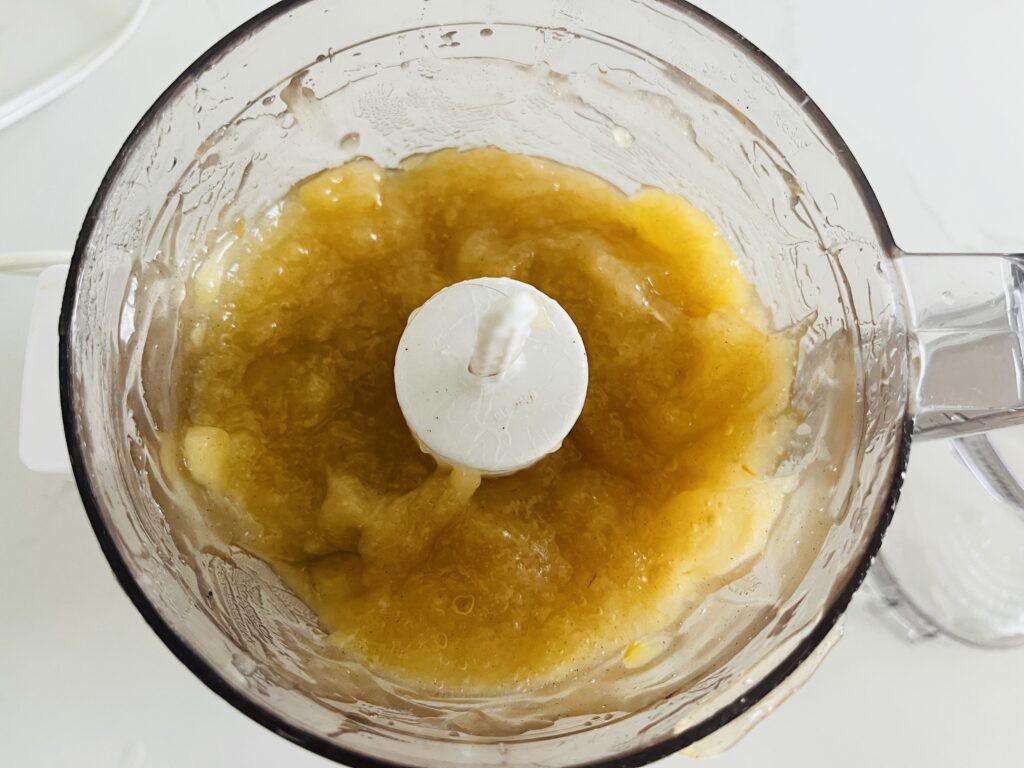 Pureed apple pie filling in a food processor. 