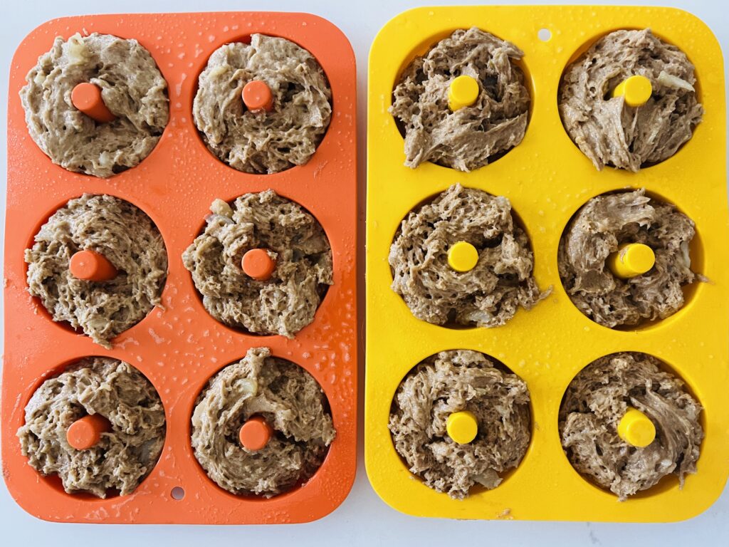 Raw donut batter in donut molds.